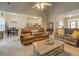 Spacious living room with high ceilings, tile floors, and comfortable leather sofas at 135 Clear Spring Lane, Oxford, GA 30054
