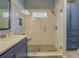 Modern walk-in shower with sleek fixtures and beautiful tile in renovated bathroom at 135 Clear Spring Lane, Oxford, GA 30054