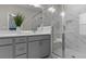 Bathroom with double sink vanity, a glass shower with white marble, and a built-in shower seat at 4651 Eddibunn Se Dr, Smyrna, GA 30080