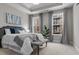 Beautifully staged bedroom featuring a large bed, three windows and an accent bench at 4651 Eddibunn Se Dr, Smyrna, GA 30080
