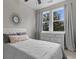 Bedroom with large window with tree view, neutral colors, and ceiling fan at 4651 Eddibunn Se Dr, Smyrna, GA 30080