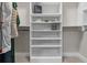 Walk-in closet featuring custom white shelving and racks for optimal storage organization at 4651 Eddibunn Se Dr, Smyrna, GA 30080