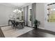 Elegant dining room featuring a chandelier, hardwood floors, and access to the balcony at 4651 Eddibunn Se Dr, Smyrna, GA 30080