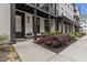 A townhome exterior has a sidewalk, garden, covered porch, and black trim at 4651 Eddibunn Se Dr, Smyrna, GA 30080