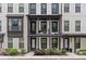 Charming townhome with a balcony, white brick, black trim, and well manicured landscaping at 4651 Eddibunn Se Dr, Smyrna, GA 30080