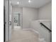 Carpeted hallway with view to the outside and featuring a white sliding barn door at 4651 Eddibunn Se Dr, Smyrna, GA 30080