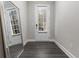 Hallway featuring hardwood floors, a mirror, and a door to the exterior at 4651 Eddibunn Se Dr, Smyrna, GA 30080