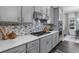 Modern kitchen with custom cabinets, stainless steel appliances, and elegant backsplash at 4651 Eddibunn Se Dr, Smyrna, GA 30080