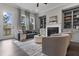 Cozy living room with fireplace, built-in bookshelves, hardwood floors, and natural light at 4651 Eddibunn Se Dr, Smyrna, GA 30080