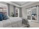 Large bedroom featuring natural light, neutral decor, and a barn door to ensuite bathroom at 4651 Eddibunn Se Dr, Smyrna, GA 30080