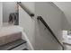 Carpeted staircase with wooden handrail leading to the laundry room with washer and dryer appliances at 4651 Eddibunn Se Dr, Smyrna, GA 30080