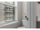 Toilet by a window with blinds, bringing in natural light to the powder room at 4651 Eddibunn Se Dr, Smyrna, GA 30080