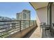 Condo balcony view of city skyline with chairs for relaxing at 750 Park Ne Ave # 18S, Atlanta, GA 30326