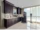 Convenient coffee bar area with stylish dark wood cabinets and modern beverage machine at 750 Park Ne Ave # 18S, Atlanta, GA 30326
