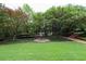 Beautifully landscaped courtyard with lush greenery and a unique bird bath fountain at 750 Park Ne Ave # 18S, Atlanta, GA 30326