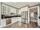 Modern kitchen with stainless steel appliances, granite counters, and views to the dining room at 750 Park Ne Ave # 18S, Atlanta, GA 30326
