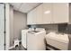 Laundry room featuring a washer, dryer, utility sink, and upper cabinets for storage at 750 Park Ne Ave # 18S, Atlanta, GA 30326