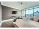 Bright main bedroom with balcony access, sleek floors, and seating area overlooking the city at 750 Park Ne Ave # 18S, Atlanta, GA 30326