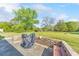 Inviting backyard with lush lawn, trees, outdoor grill, and a cozy fire pit at 1955 Starr Sw Rd, Conyers, GA 30094