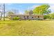 Sprawling backyard with a patio, mature trees, and a lush lawn, perfect for outdoor enjoyment at 1955 Starr Sw Rd, Conyers, GA 30094