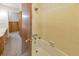 Bathroom bathtub with yellow tile, shower head, and gold fixtures at 1955 Starr Sw Rd, Conyers, GA 30094