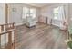 Bedroom with hardwood flooring, crib, windows, a comfortable chair, and neutral tones at 1955 Starr Sw Rd, Conyers, GA 30094