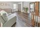 Bedroom with hardwood flooring, crib, windows, a comfortable chair, and neutral tones at 1955 Starr Sw Rd, Conyers, GA 30094