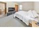 Neutral bedroom featuring a bed, TV, large carpet, and a window providing natural light at 1955 Starr Sw Rd, Conyers, GA 30094