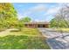 Charming single-story home featuring a spacious front yard and convenient covered parking at 1955 Starr Sw Rd, Conyers, GA 30094