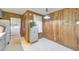 Kitchen with wood paneled accent wall and view of a laundry room with washer and dryer at 1955 Starr Sw Rd, Conyers, GA 30094