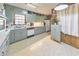 Bright kitchen with painted cabinets, white appliances, subway tile backsplash, and natural light at 1955 Starr Sw Rd, Conyers, GA 30094