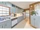 Kitchen with gray cabinets and stainless steel appliances; a view of the laundry room with washer and dryer can be seen at 1955 Starr Sw Rd, Conyers, GA 30094