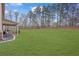 Expansive backyard featuring a lush green lawn and mature trees, perfect for outdoor activities and relaxation at 8033 Louis Dr, Locust Grove, GA 30248