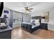 Bedroom featuring wood floors, a ceiling fan, and neutral paint at 8033 Louis Dr, Locust Grove, GA 30248