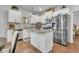 Modern kitchen with stainless steel appliances, granite countertops, and white cabinets at 8033 Louis Dr, Locust Grove, GA 30248
