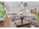 Open-concept living room with hardwood floors, neutral paint, and a decorative ceiling fan at 8033 Louis Dr, Locust Grove, GA 30248