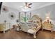 Elegant main bedroom with decorative walls, hardwood floors, and lots of natural light at 8033 Louis Dr, Locust Grove, GA 30248
