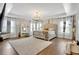 Sunlit main bedroom with hardwood floors, a ceiling fan, and natural light at 8033 Louis Dr, Locust Grove, GA 30248