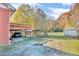 Spacious backyard featuring a covered carport, storage shed, and mature trees at 831 Sinyard Rd, Lithia Springs, GA 30122