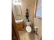 Tiled bathroom with a vanity, toilet, and blinds offering privacy and natural light at 831 Sinyard Rd, Lithia Springs, GA 30122