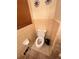 Modest bathroom featuring a toilet, tiled walls, and a window with blinds at 831 Sinyard Rd, Lithia Springs, GA 30122