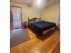 Bedroom with hardwood floors, a classic wooden bed frame, and natural light at 831 Sinyard Rd, Lithia Springs, GA 30122