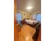 Bedroom with hardwood floors, a cozy bed, and a bright window with natural light at 831 Sinyard Rd, Lithia Springs, GA 30122
