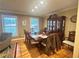Traditional dining room with hardwood floors, large windows, and an elegant china cabinet at 831 Sinyard Rd, Lithia Springs, GA 30122