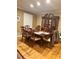 Traditional dining room with hardwood floors, large windows, and an elegant china cabinet at 831 Sinyard Rd, Lithia Springs, GA 30122