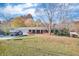 Single-story brick home with mature trees and a spacious front yard at 831 Sinyard Rd, Lithia Springs, GA 30122
