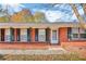 Inviting front porch with brick trim, decorative iron posts, and a stylish white front door at 831 Sinyard Rd, Lithia Springs, GA 30122