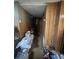 Hallway with wood paneling and cluttered floor at 831 Sinyard Rd, Lithia Springs, GA 30122