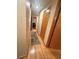 Hallway with hardwood floors and multiple doors, providing access to different rooms in the home at 831 Sinyard Rd, Lithia Springs, GA 30122