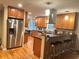Spacious kitchen featuring wooden cabinets, stainless steel appliances, and a breakfast bar with seating at 831 Sinyard Rd, Lithia Springs, GA 30122